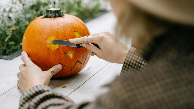 A girl carving a pumpkin